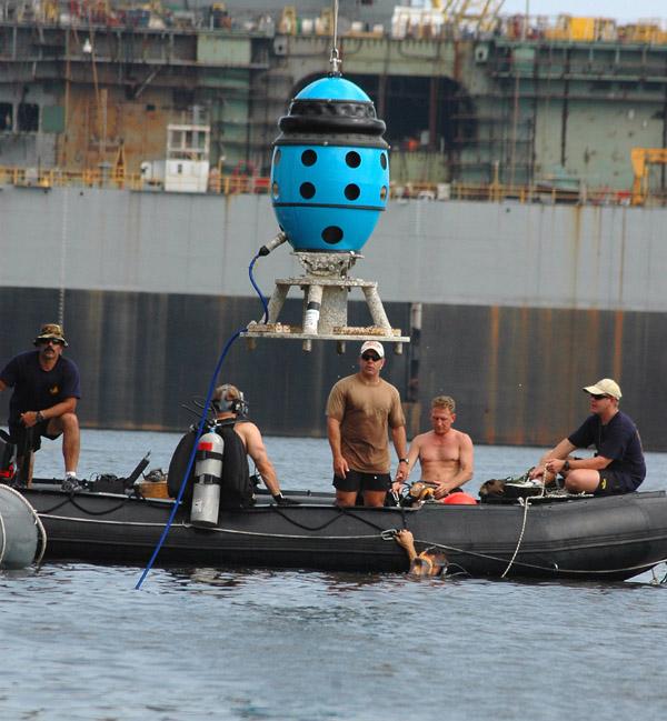 NAVAIR News Release (EODMU-12) Det 10 prepare to guide the Cerberus Swimmer Detection System into the water at Naval Station Pascagoula during the Gulf Coast Maritime Domain Awareness Initiative 2005.