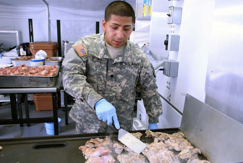Spc. Jose D. Bravo, Foxtrot Co., 250th Brigade Support Battalion, grills chicken inside a military mobile kitchen trailer at Stand Down of North Jersey, Oct. 12, 2013.