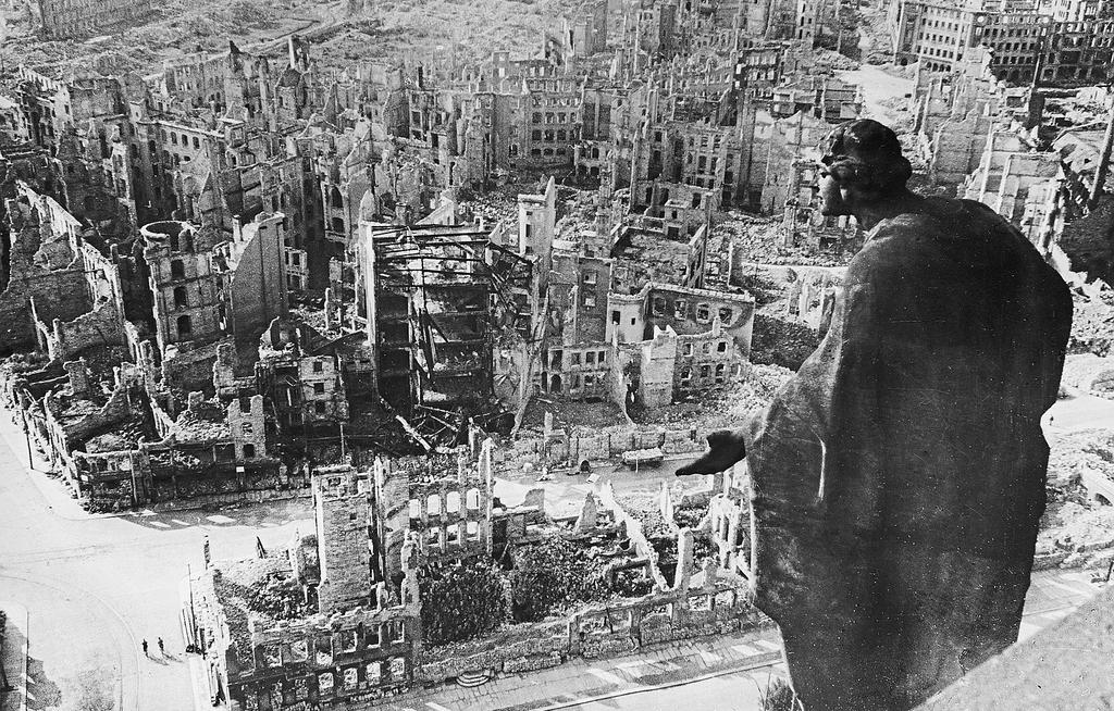 7 A cathedral statue overlooking Dresden, Germany, after a devastating firebombing by the Anglo-American Combined Bomber Offensive.