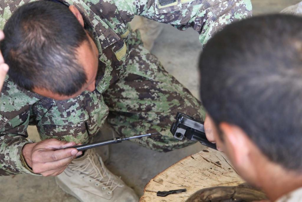 120627-M-LW625-090 An Afghan National Army (ANA) soldier with 2nd Tolai, 3rd Kandak, 215th Corps inserts the firing pin into the bolt of a Browning M2.