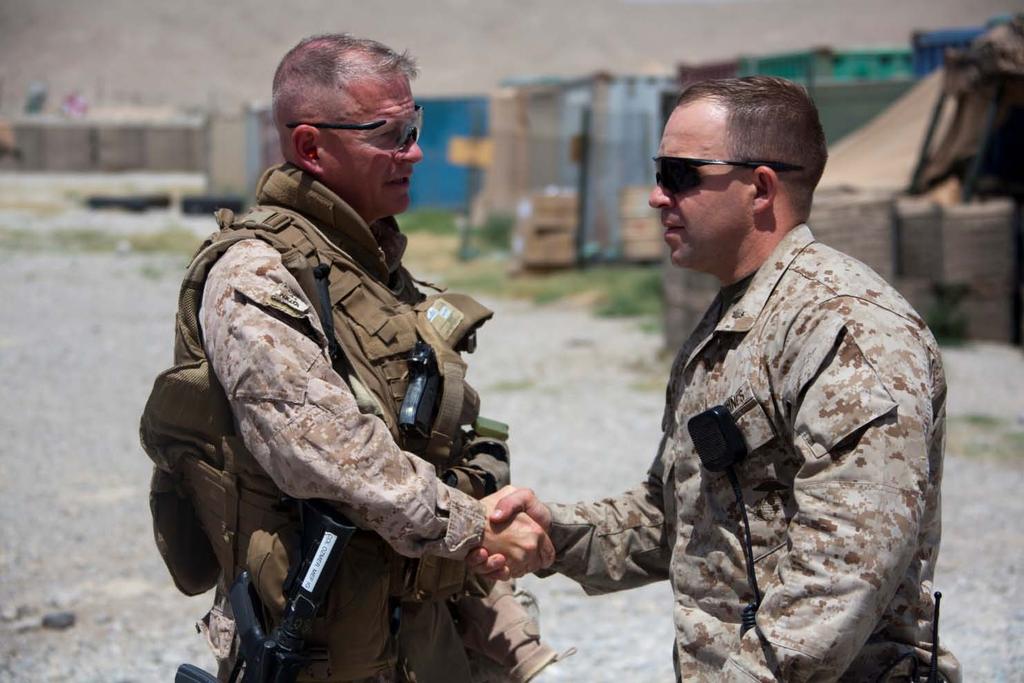 120626-M-EU691-026 U.S. Marine Corps Col. Paul Ozmer, left, the inspector general for Regional Command (Southwest), shakes hands with Maj.