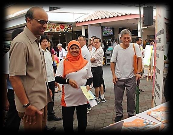 Community Events Mr Tharman visiting LHMSCJ booth Loving Heart Staff tending the booth Happy Minds Happy Lives