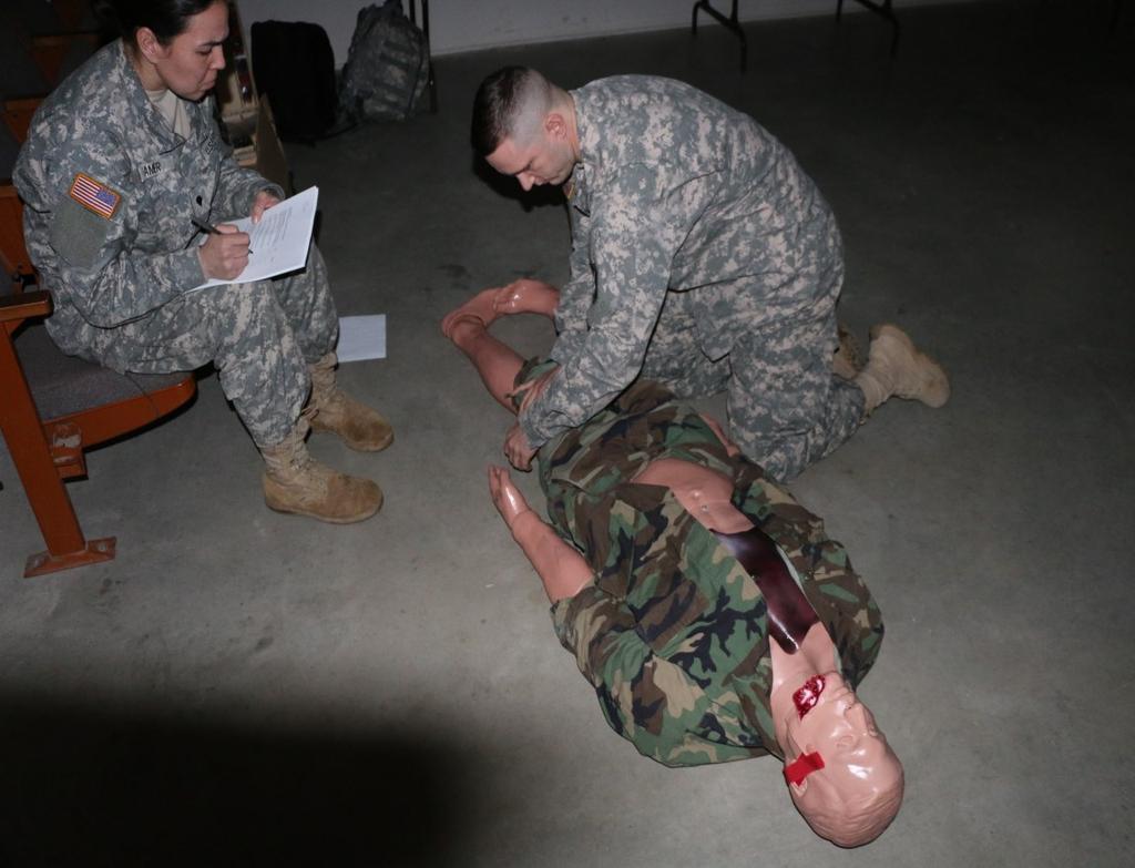 Page 4 310TH ESC SHOWING SKILL WITH THE BASICS FORT A.P. HILL, Va While caring for the casualty at his feet, Sgt. Richard M.