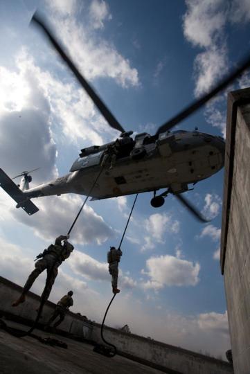 U.S. Army Soldiers conduct fast rope insertion and extraction training at the Military Operations on Urban Terrain site. The Soldiers utilize a U.S. Navy MH-60 Seahawk helicopter for training at Exercise Southbound Trooper IX at Fort Pickett, Va.