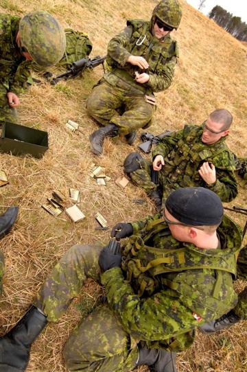 Canadian Army Soldiers from 1st Battalion, Nova Scotia Highlanders (North), load ammunition before a live-fire exercise at Fort Pickett, Va. Feb. 16, 2009.
