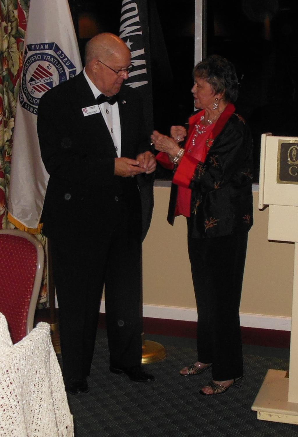 Outgoing President LtCol. Jerry Koontz and New President Mrs. Joyce Harte exchanges old and new president pins.