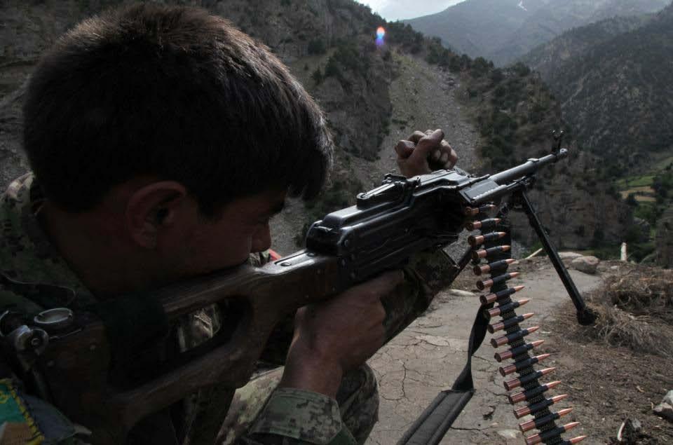 An Afghan National Army Soldier pulls security on the town of Barge Matal as part of Operation