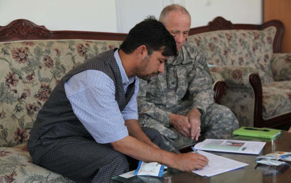 Professor Nan Naser and U.S. Army Col. James Floyd, team veterinarian, work on the details of a livestock project at the university.