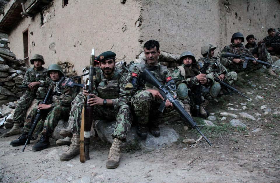 Afghan National Army (ANA) Soldiers of 201st ANA Corps relax after a night assault on the town of Bachancha as part of Operation