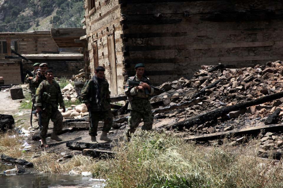 Afghan National Army (ANA) Soldiers of the 201st ANA Corps move through the town of Barge Matal as part of Operation