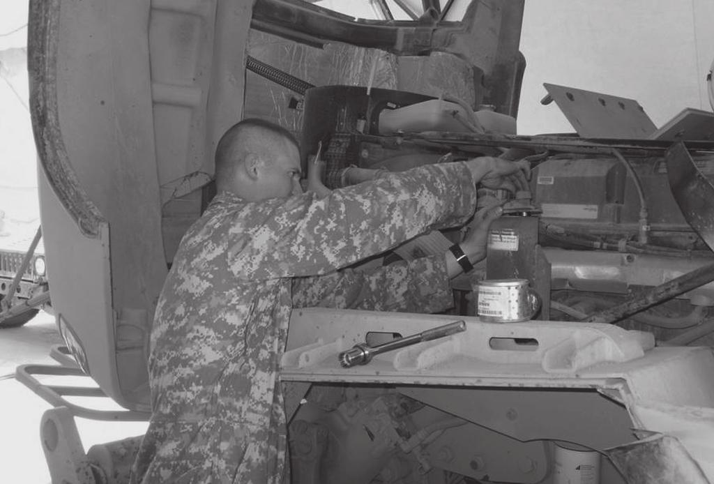 An FSC Soldier services an M916 light equipment transporter at Camp Striker, Iraq. supplies transported by the FSC and relies heavily on the FSC for the requisition and use of Class IX repair parts.