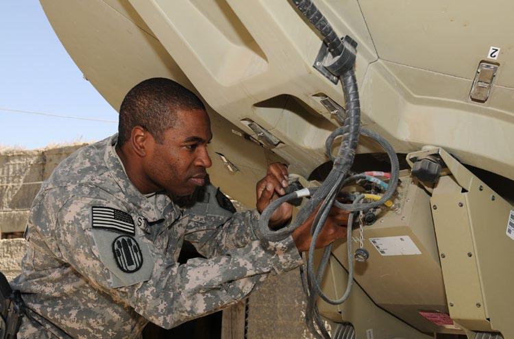 Chief Warrant Officer 2 Clinton Store, network operations and satellite terminal technician for the 196th Maneuver Enhancement Brigade, South Dakota Army National Guard, performs a routine check on a