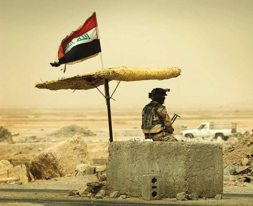 Freedom s Focal Point An Iraqi army soldier stands watch at a checkpoint July 31 near Hayy Ash Shu lah in