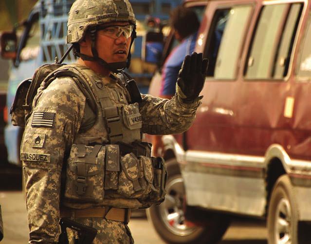 Conrad Vasquez, 2nd Squadron, 14th Cavalry Regiment, 25th Infantry Division, directs traffic on a freeway