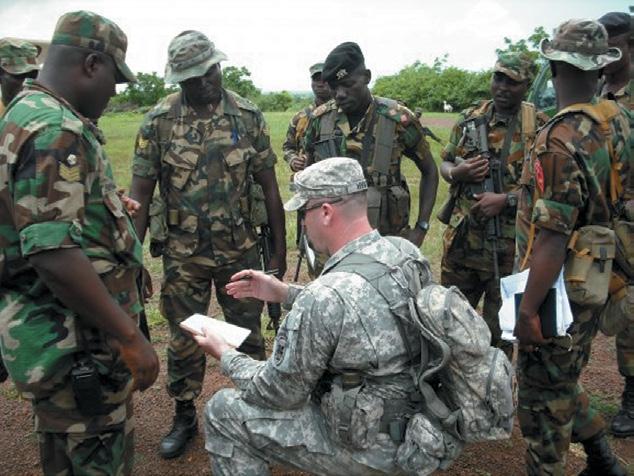 (C. Todd Lopez) Sgt. 1st Class Grady Hyatt, with U.S. Army Africa, leads an after-action review with soldiers of the Ghana Army.