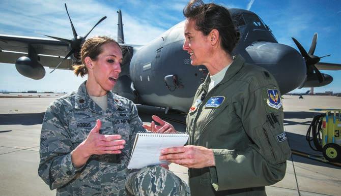 Maj. Kristen Hobbs, left, Cyber Blue Book liaison, Air Force Operational Test and Evaluation Center, speaks with Lt. Col. Michele Boyko in front of an MC-130J Commando II at Kirtland AFB, N.M.