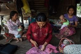 A woman preparing medicine for her mother in Roka, western Cambodia, a farming village where more