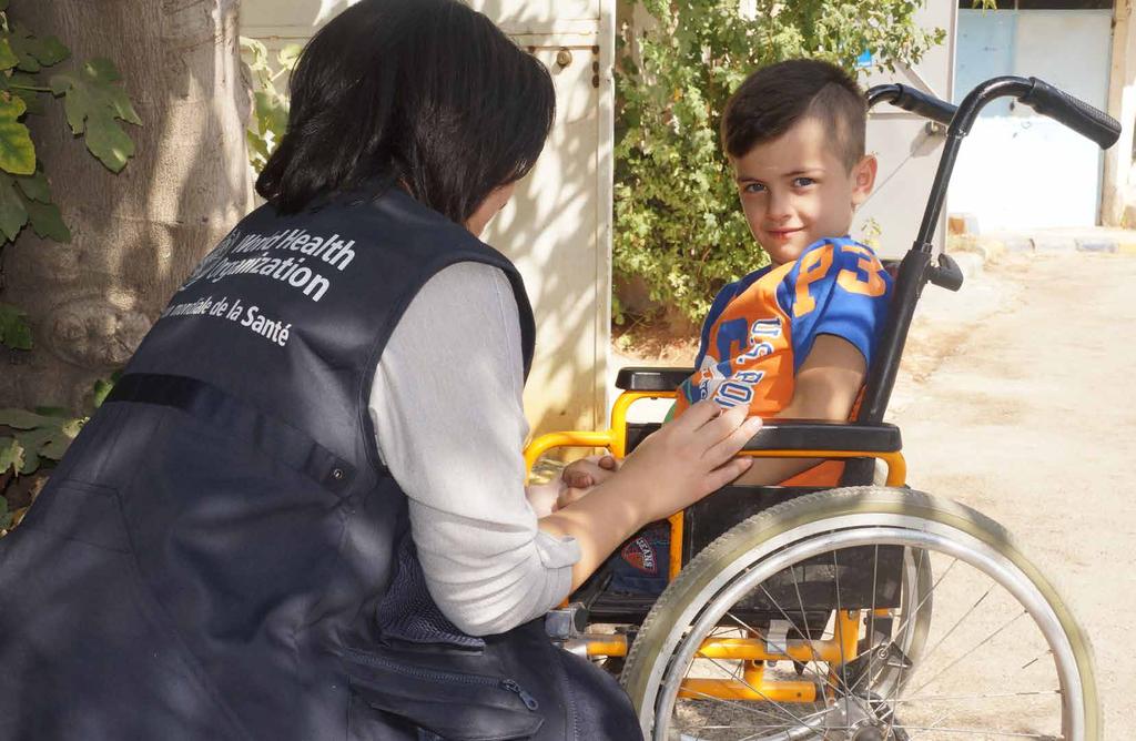 A WHO staff member visiting a disabled child at the WHOsupported physical