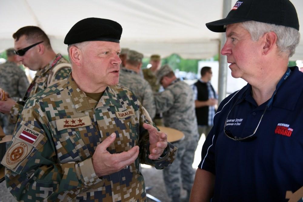 Lt. Gen. Raimonds Graube, chief of defense of the Republic of Latvia, talks with Michigan Gov. Rick Snyder. (National Guard photo by Sgt.