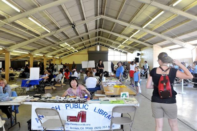 Two halls at the Antioch Fairgrounds were filled with over 100 volunteers who offered ahost of services for the homeless including access to library cards, dental care, health exams, wheelchair