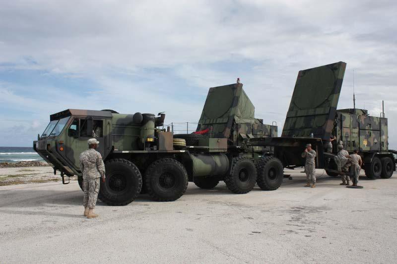 Soldiers from A Battery, 1st Battalion, 1st Air Defense Artillery, couple the radar trailer to its truck during operations on Kwajalein Atoll.