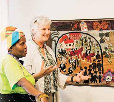 Rhodes University Fine Art Biotech Students with Professor Another Person Noseti Makubalo and Dr Carol Hofmeyr of the Keiskamma Art Project speaking about the Rhodes University Tapestry at the formal