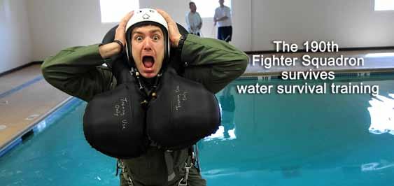 Capt. Jason Attinger, a pilot from the 190th Fighter Squadron, braces for impact as he is pulled into water during water survival training, May 5, at the Idaho State Police Training Facility in
