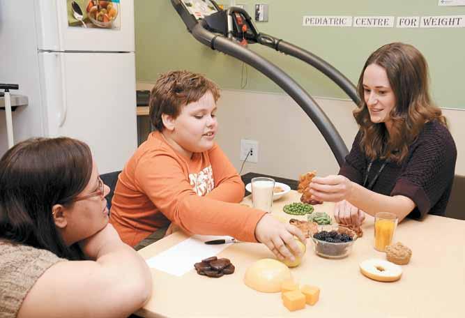 PAGE 4 a t y o u r s e r v i c e Services in your community Dawn Hersey, left, watches her son, Brandon McMeckan, work with Alberta Health Services registered dietitian Janelle Stefanyk on a food-