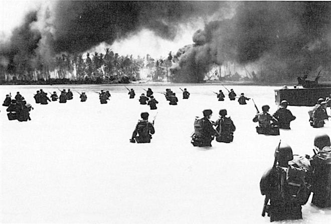 Troops of the 2d Battalion, 165th Infantry, struggle to shore on Yellow Beach on Butaritari Island following a naval gunfire bombardment.