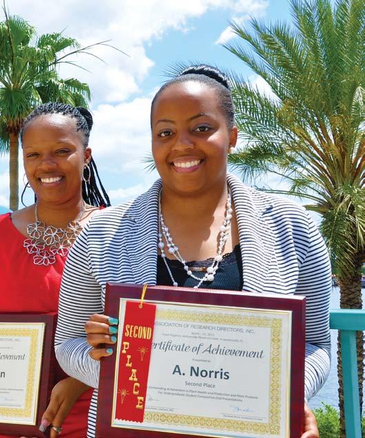 Students Millicent Cosby, Cynthia Allen and Ashley Norris hold awards presented at the 17th Biennial Research Symposium in Jacksonville, Fla. April 2013.