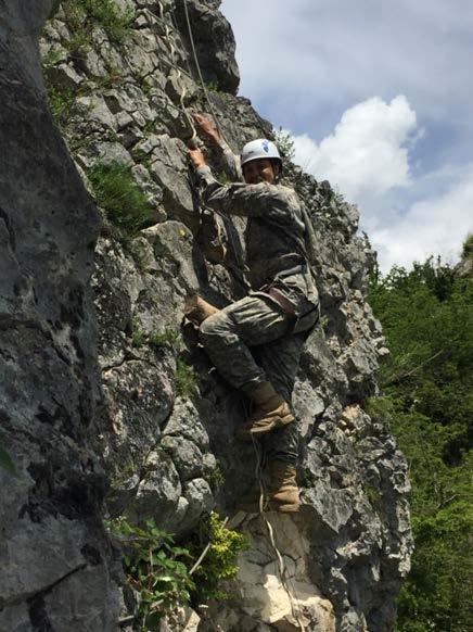 Military to Military Engagements: Cadet climbing the fixed rope at the