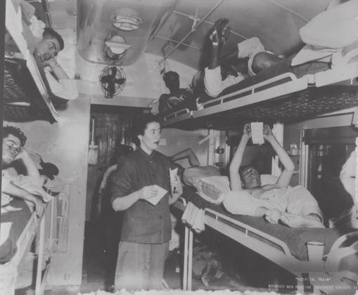 Photograph, Wounded men receive treatment on a train enroute to