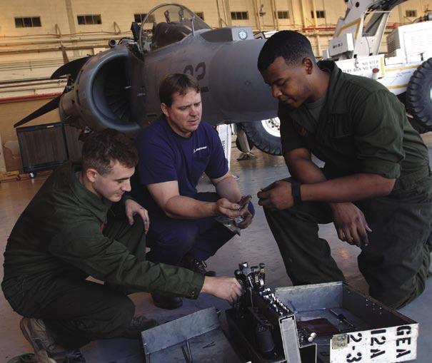S [ ] >> TOP: Boeing Contract Maintenance Technician Andy Davison (center) and two