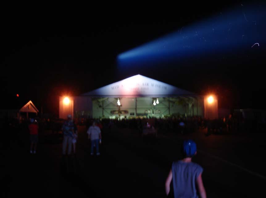 While event attendees danced, the searchlight put a beam over the hanger.