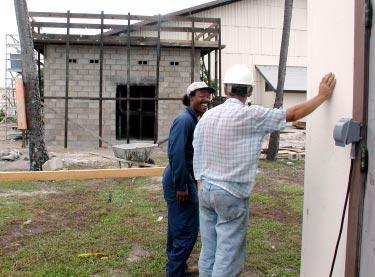 (Photo by Jim Bennett) Standing by an aged transformer building, Darryl McKinley discusses construction issues with