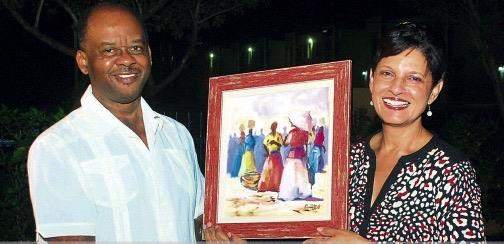Ambassadorial Corps Scholarship Fund Businessman Fred Smith (left) presents Dr Luz Longsworth, Campus Director, University of the West Indies, Western Jamaica, with a gift as a token of appreciation