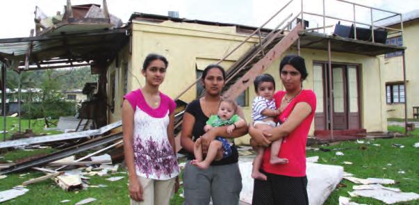 A family returns home to survey the damage left by Tropical Cyclone Yasi.