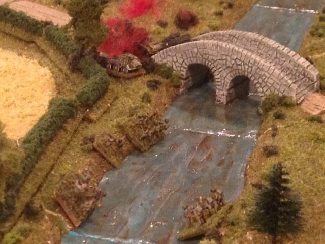 Inspired by the destruction of the second German AFV, the Scott rolled forward to cross the bridge.