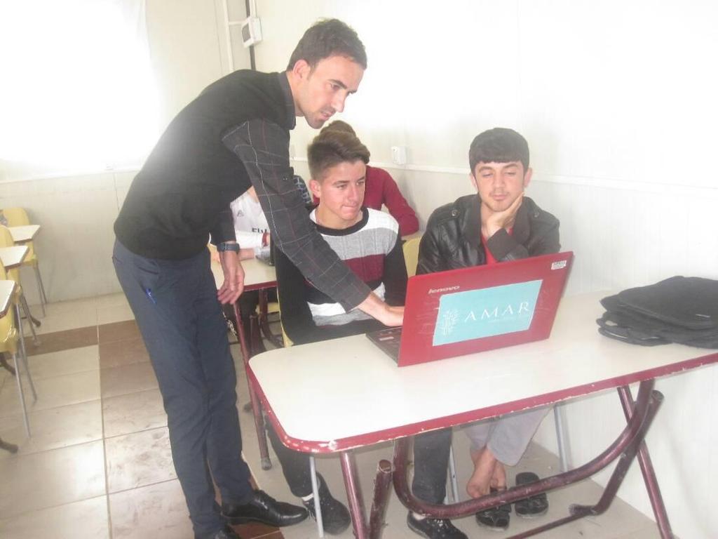 Boys learn practical Information Technology from their teacher in the vocational training centre, April 2017 6.