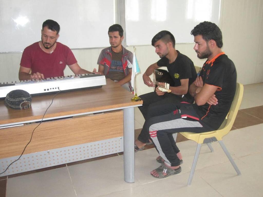 Young men learn how to play traditional and