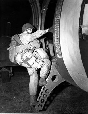 A paratrooper boards an airplane that will drop him over the coast of Normandy for the Allied Invasion of Europe, D- Day, June 6, 1944.