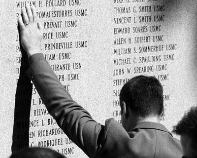 A man stops to touch the name of a fallen loved one at the Beirut Memorial on Camp Johnson, N.C. Photo credit: Cpl.