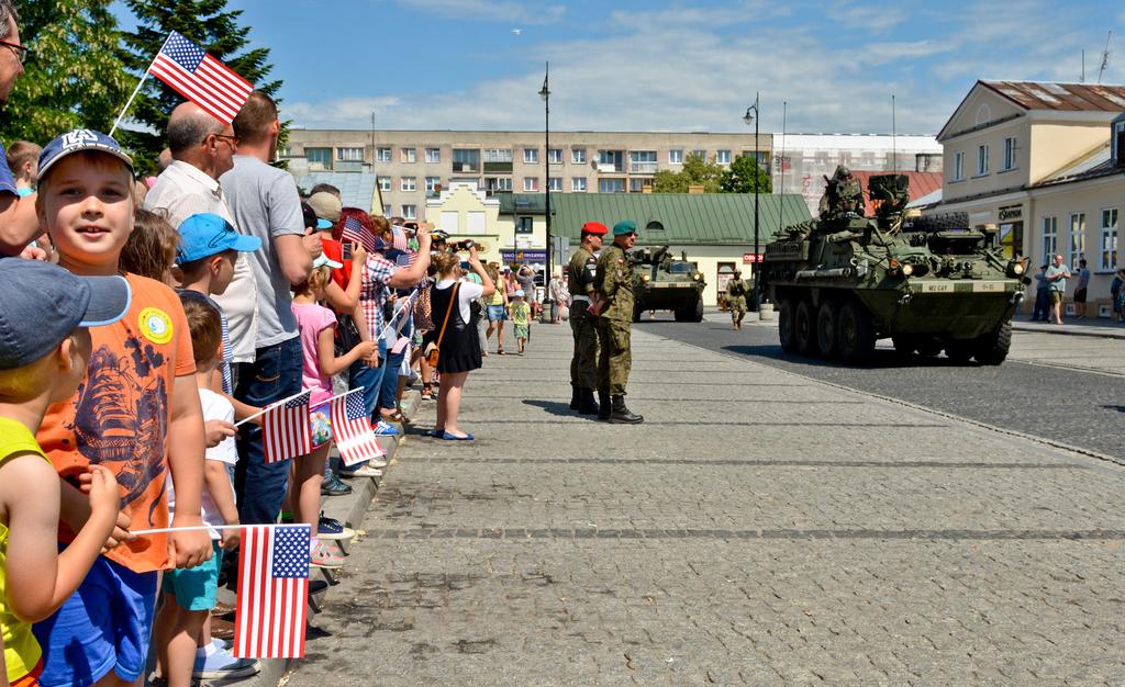 Soldiers of 4th Squadron, 2nd Calvary Regiment drive Stryker combat vehicles through the main square of Suwalki, Poland, 4 June 2016 during Exercise Dragoon Ride.