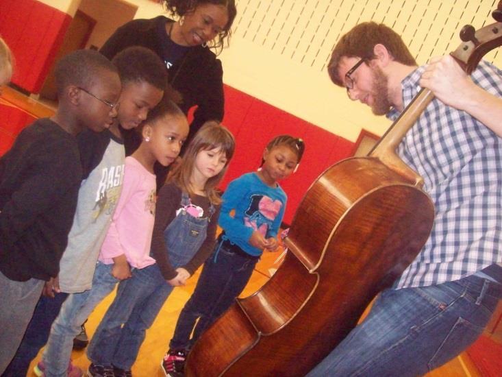 As part of an Arts Midwest Touring Fund engagement, elementary school students learn about and listen to the sounds the cello from a member of Aelous Quartet at the Fischoff National Chamber Music