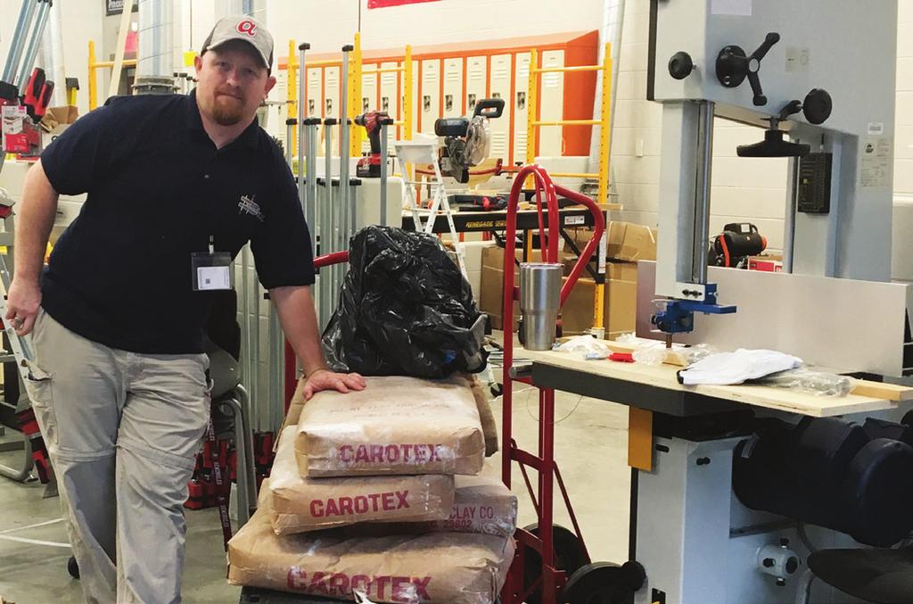 Paul Fussell, a teacher with Fulton Schools College and Career Academy receives a donation of Carotex courtesy of Swofford Construction and Oldcastle.