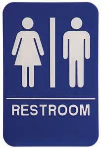 Look for the rest room sign posted on the door ahead. Restrooms will be through the door and down the stairs.