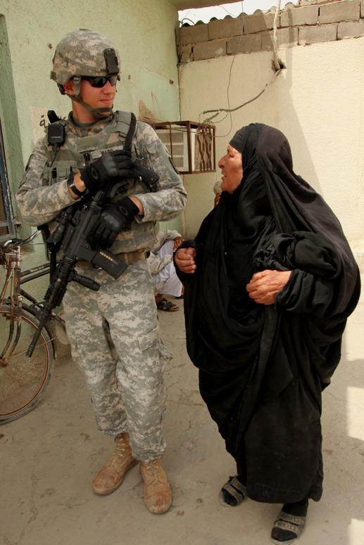 U.S. Army Photo by Spc. Samantha R. Ciaramitaro/Released An Iraqi woman speaks to U.S. Army Staff Sgt. Samuel Ward, from Jefferson, Mo.