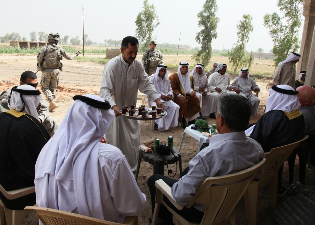 Chai tea is served at a meeting with Sheiks and representatives from the Environmental Provincial Reconstruction Team at a demonstration farm in Taji, Iraq, May 23, 2010.