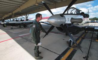 Eric Reichert checks out a T-6 before a mission.