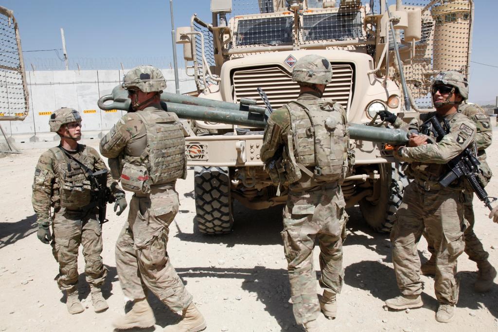 U.S. soldiers with Red Platoon, Apache Troop, 1/75th Cavalry Battalion, 2nd Brigade, 101st Airborne Division (Air Assault), move a tow bar
